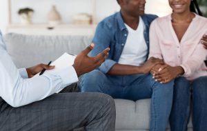 Image of an African American couples meeting with a couples therapist in Chapel Hill, NC. Showing what you can expect from online couples therapy and marriage counseling in North Carolina. 