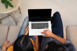 Image of an indian couple getting onto their laptop for online marriage counseling in Chapel Hill, NC. Showing that whether you are in Durham, Raleigh or anywhere else in North Carolina an online couples therapist can help you.