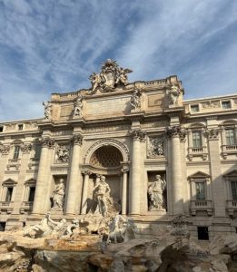 Trevi Fountain in Rome with visitors – iconic crowded travel spot highlighting coping skills for PTSD while traveling.